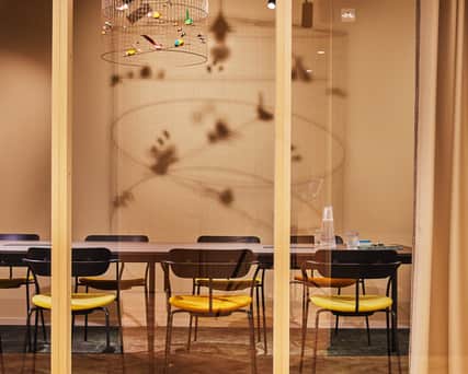 A meeting room behind glass walls.