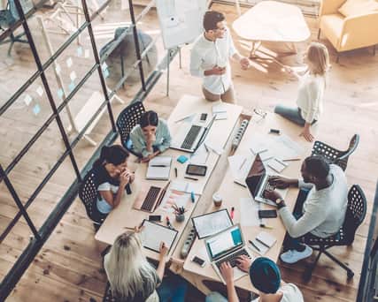 People sitting around a big desk.